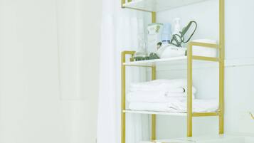 Shower, hair dryer, towels, shampoo
