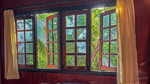 A room with a large window, two chairs, and a small table. - Marissa Hotel (Ko Pha-ngan)