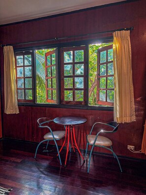 A room with a large window, two chairs, and a small table. - Marissa Hotel (Ko Pha-ngan)