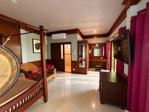 A room with a bed, a television, and a wardrobe. - Marissa Hotel (Ko Pha-ngan)