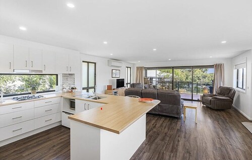 Beautiful modern, upstairs apartment with stunning water and mountain views.