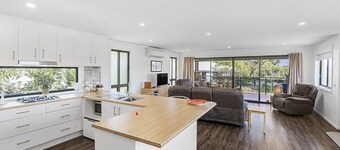 Beautiful modern, upstairs apartment with stunning water and mountain views.