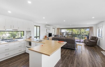 Beautiful modern, upstairs apartment with stunning water and mountain views.