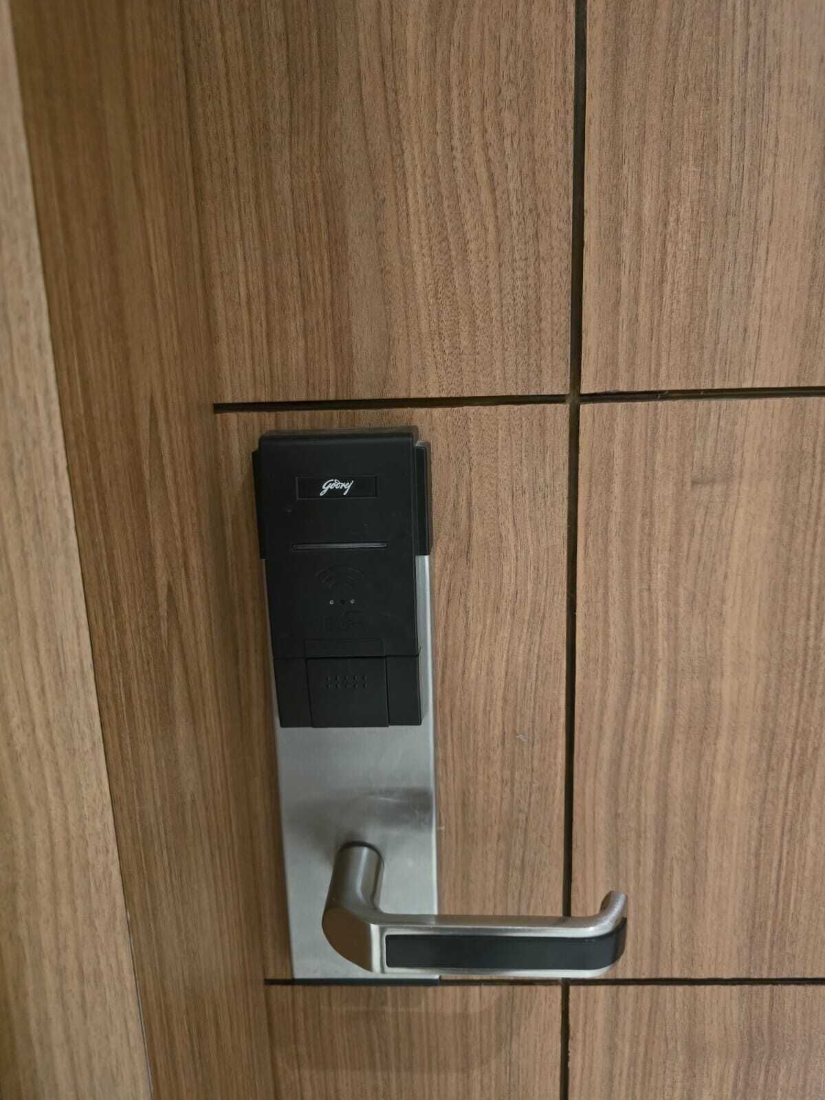 A modern door with a keyless entry system and a metallic handle.