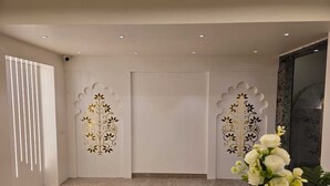 Ein modernes Interieur mit Marmorboden, weißen Wänden und dekorativen Paneelen mit floralen Mustern.