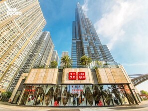 A modern building with a prominent sign for UNIQLO. - Vinhomes Urban Apartment HCM (Ho Chi Minh City)
