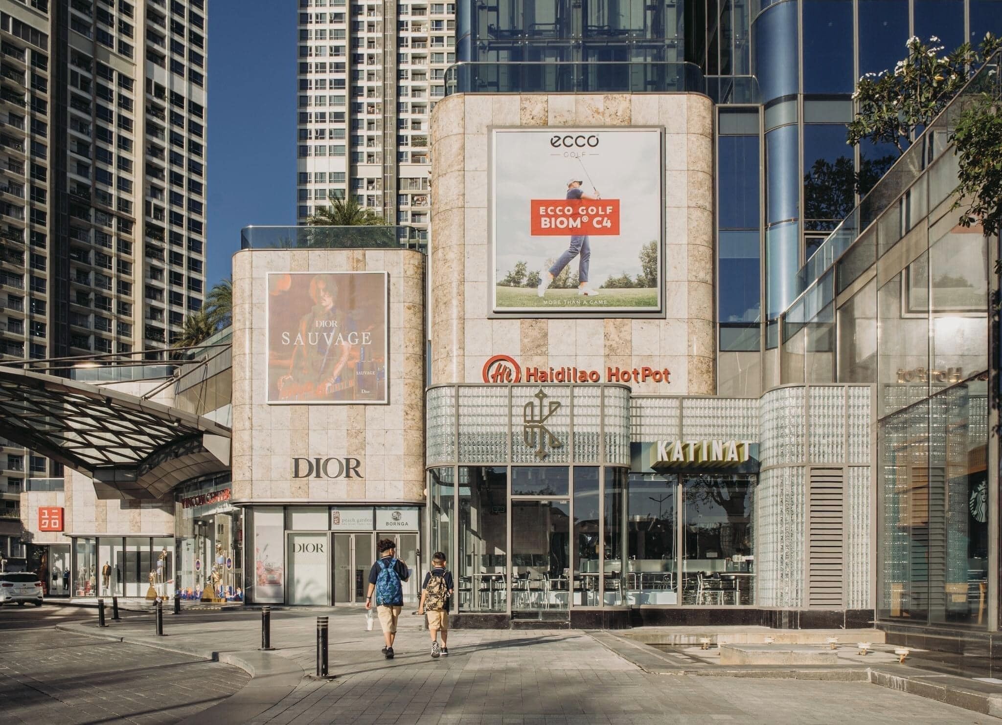A modern building with a Dior store and a Haidilao HotPot restaurant.