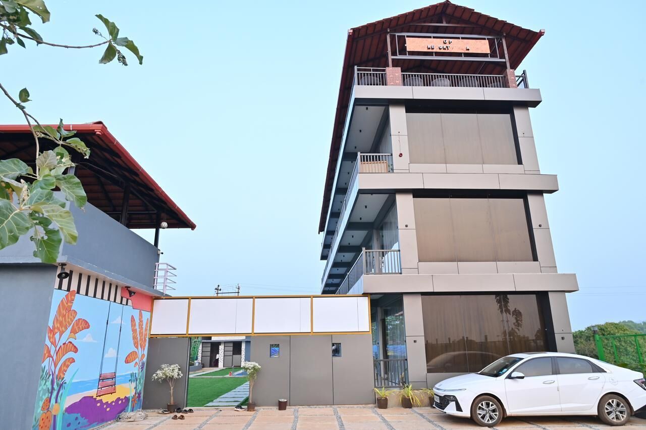 A multi-story building with a modern architectural design, featuring a balcony on the upper floor.