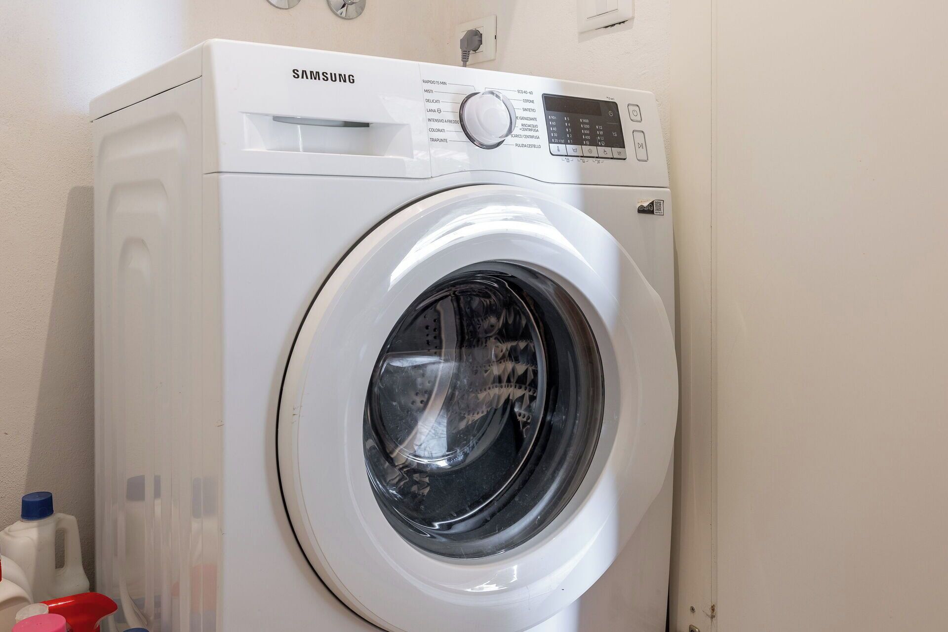 A Samsung front-loading washing machine in a laundry room.