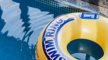 A yellow inflatable ring with 'RIM' and 'RING' text, floating on water.