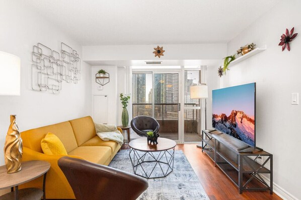 A modern living room with a sofa, coffee table, and TV.