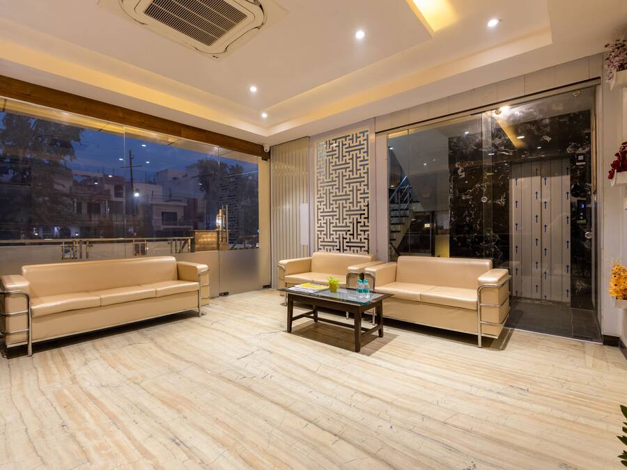 A modern living room with two sofas, a coffee table, and a large window.
