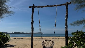 On the beach, white sand, beach umbrellas, beach towels