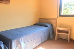 1 bedroom, in-room safe, travel cot - Comfortable 28 sq. m. two-room apartment featuring a fully equipped kitchenette, a double sofa bed, two single beds, and a private bathroom with shower, bidet, and hairdryer. The apartment also features an outdoor space with sea views, a patio or terrace (Stintino)