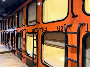 A row of bunk beds with individual compartments, each marked with a number. - Factor Inn - Old Quarter Centre (Hanoi)