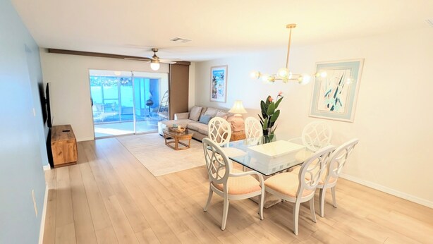Dining - Retro coastal Fort Myers retreat with private yard, spa & fire pit. Two bedrooms, two baths, sun room with fitness wall, screened patio, and easy access to RSW, FGCU, shopping, and beaches. (Fort Myers)