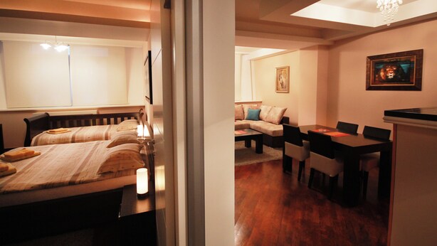 A hotel room with a bed, a desk, and a sofa. - Standard 1-bedroom apartment in Strong Center of Belgrade with Private Garage (Beograd)