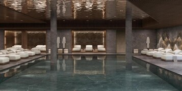 Una piscina cubierta, tumbonas