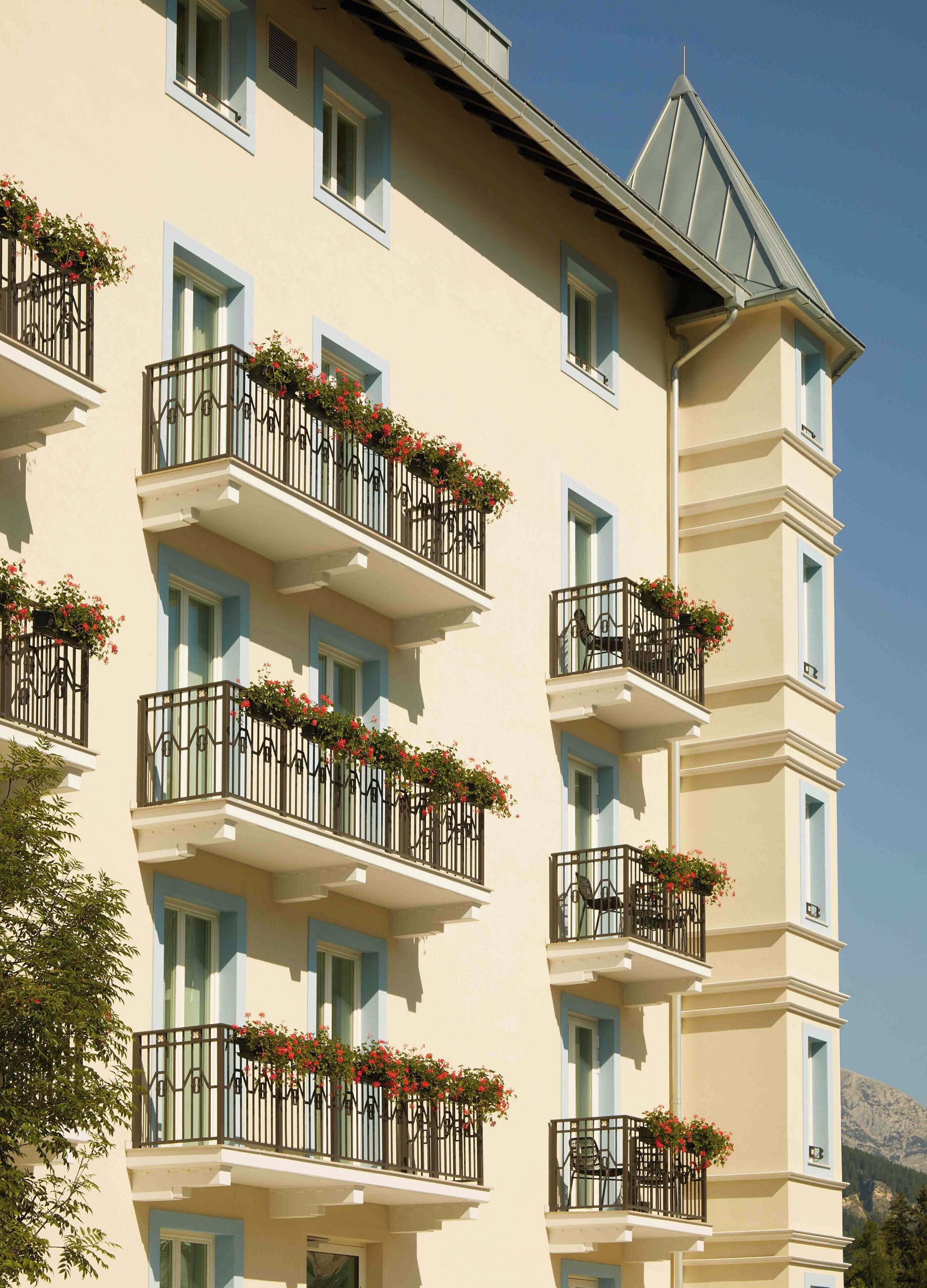 A multi-story building with balconies adorned with flower boxes.