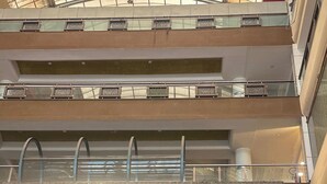 A multi-level building with balconies, railings, and a glass facade. - Mahaveer Residency Hotel (Thane)