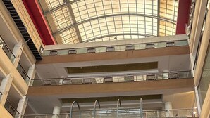 A multi-level atrium with glass railings and a curved glass ceiling. - Mahaveer Residency Hotel (Thane)