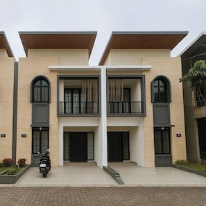 A modern two-story building with a symmetrical facade, large windows, and a central entrance. - Arumi Experience Tasikmalaya Syariah (Tasikmalaya)