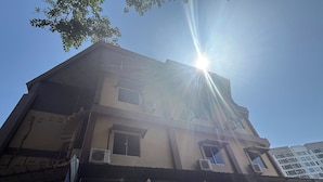 A multi-story building with a flat roof, several windows, and air conditioning units. - Aikka Hotel (Butterworth)