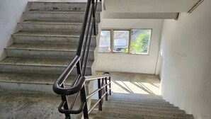 A staircase with metal railings leading to a landing. - Toucan Garden (Bang Phli)