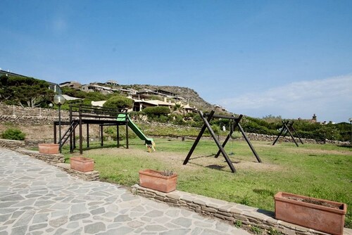 Functional 28 sq m room.Comprising a double bed, two single beds, and a private bathroom with shower, bidet, and hairdryer. The room also features an outdoor space with a sea view, a patio or terrace, and a table and chairs. Breakfast is included in the 