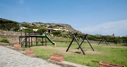 Functional 28 sq m room.Comprising a double bed, two single beds, and a private bathroom with shower, bidet, and hairdryer. The room also features an outdoor space with a sea view, a patio or terrace, and a table and chairs. Breakfast is included in the