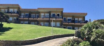 Functional 28 sq m room.Comprising a double bed, two single beds, and a private bathroom with shower, bidet, and hairdryer. The room also features an outdoor space with a sea view, a patio or terrace, and a table and chairs. Breakfast is included in the 