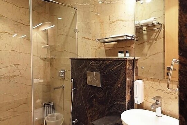 Shower, rainfall showerhead, slippers, towels
