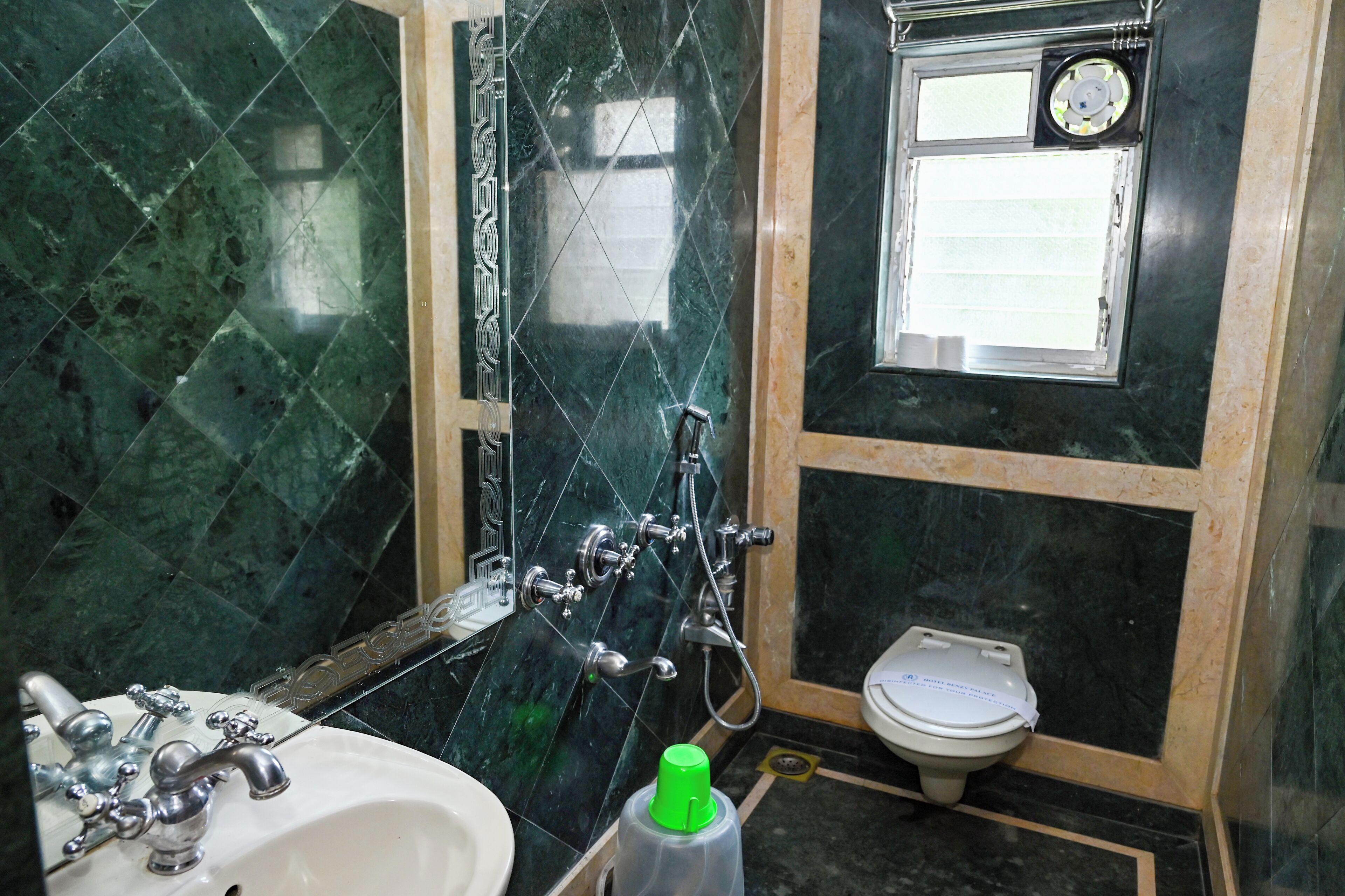 A bathroom with a sink, mirror, shower, and toilet.