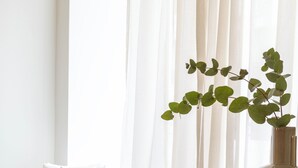 A round table with a beige cushion, a brown bowl, and a green plant. - Milioni by Oniro (Athens)