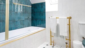 A modern bathroom with a bathtub, a glass shower enclosure, and a toilet with a bidet attachment. - Our Cosy Cottage in Gatehouse of Fleet (Gatehouse of Fleet)