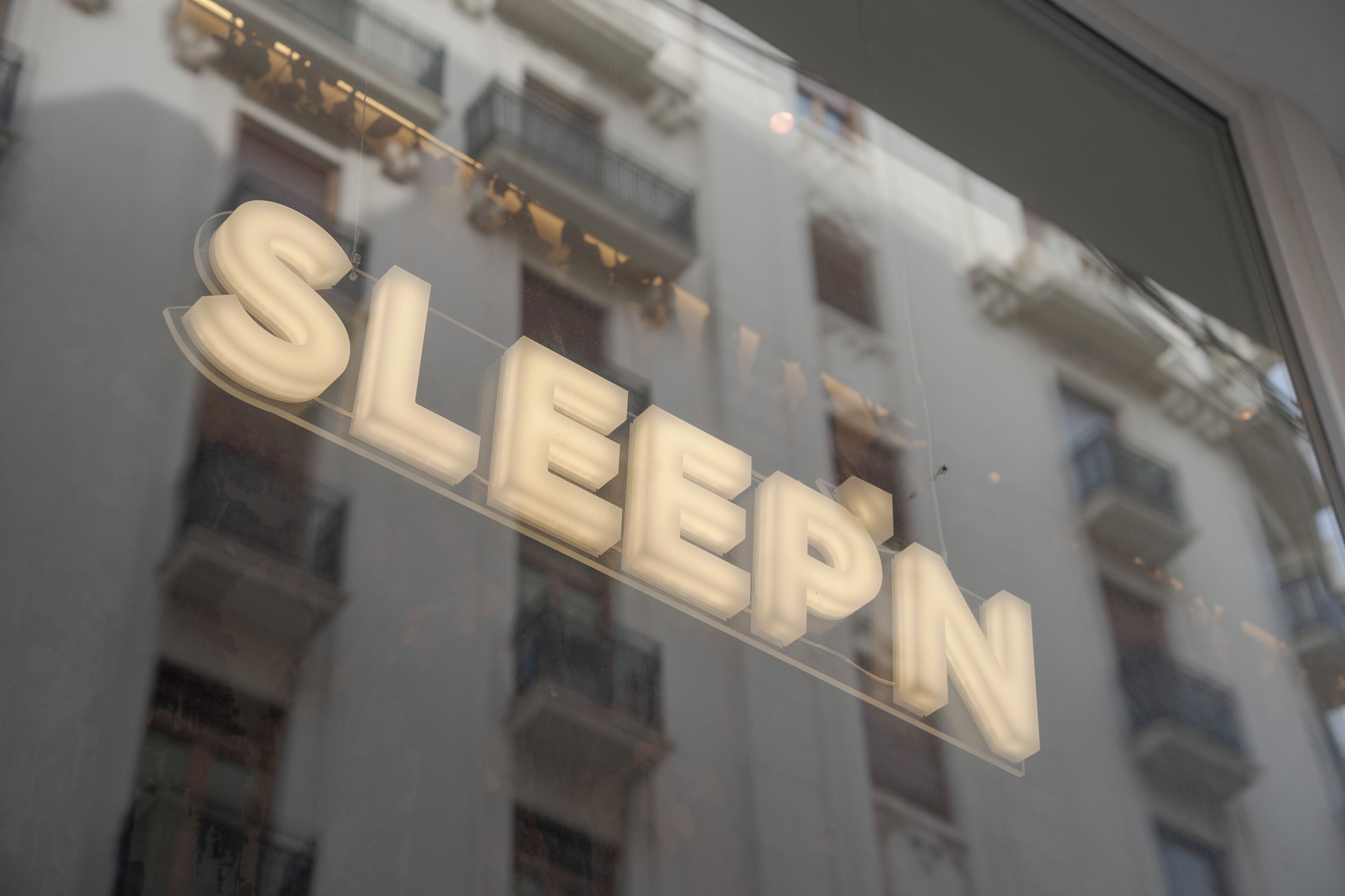 A sign with the word 'SLEEPIN' in large letters, indicating a hotel or accommodation.
