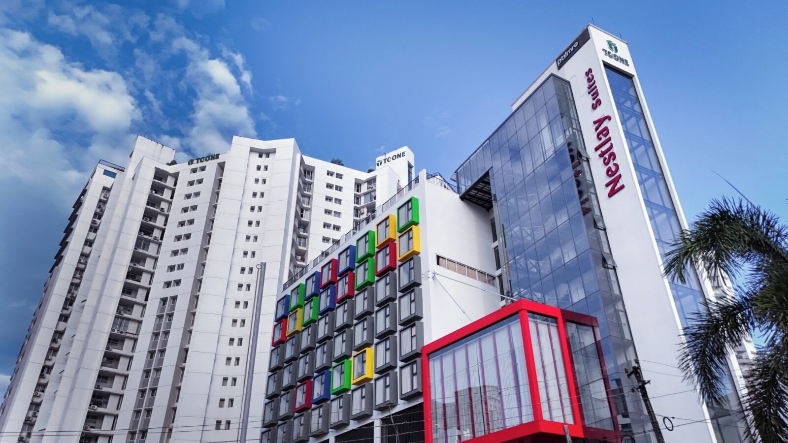 A modern high-rise building with multiple floors, featuring a mix of residential and commercial spaces.