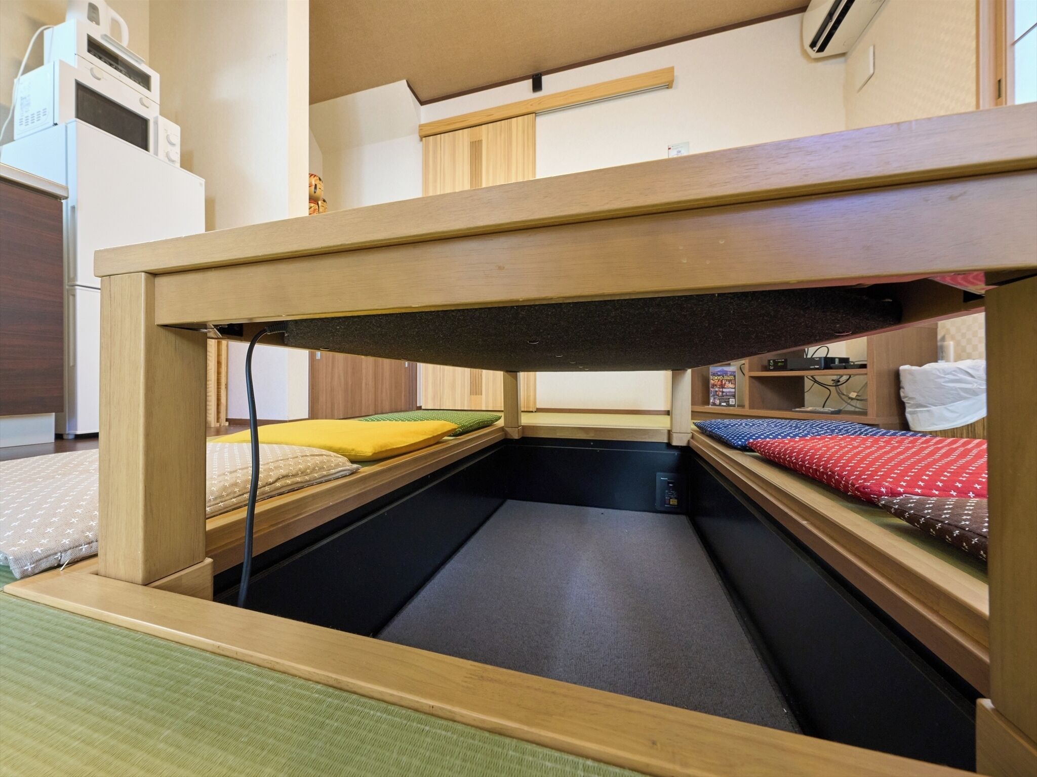 A bunk bed with a wooden frame, a mattress, and a pillow.