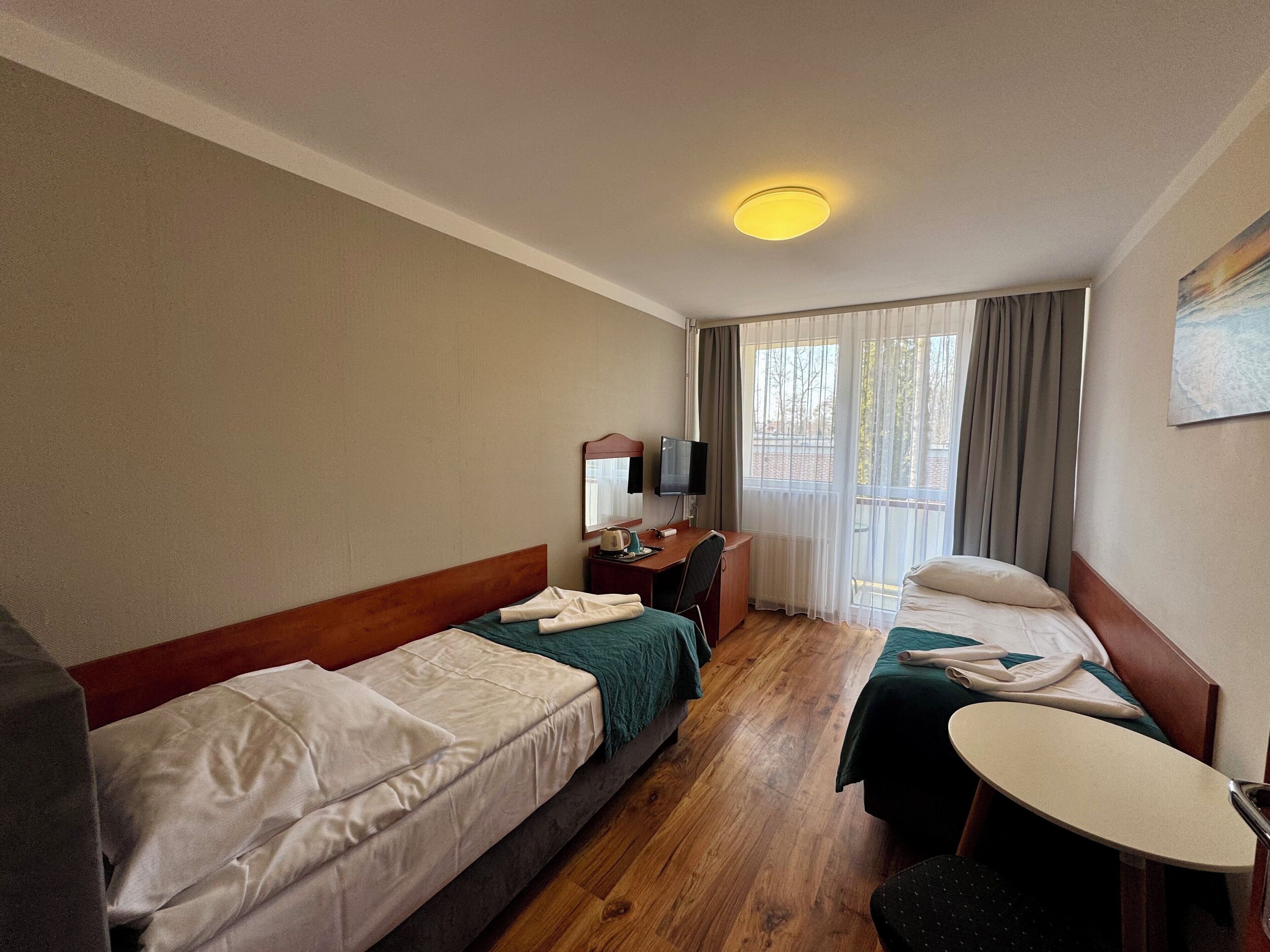 Desk, laptop workspace, blackout drapes, iron/ironing board