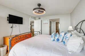 A bedroom with a bed, dresser, TV, and a ceiling fan. - 3BR Beachfront Condo w/ Pools & Balcony (South Padre Island)