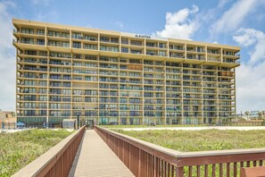 A multi-story hotel with balconies, a boardwalk, and a beach view. - 3BR Beachfront Condo w/ Pools & Balcony (South Padre Island)