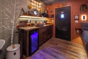 A kitchen with a built-in dishwasher, wooden cabinets, a sink, and a microwave. - 66-THE FOUR TREE-SONS (Sevierville)