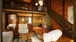 A spacious living area with a wooden staircase, a kitchen, and a dining area. - 2BR Getaway with WiFi, Grill & SHARC Passes (Sunriver)