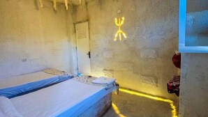 A room with a bunk bed, a door, and a wall with a neon sign. - Double Room (Marsa Matrouh Governorate)