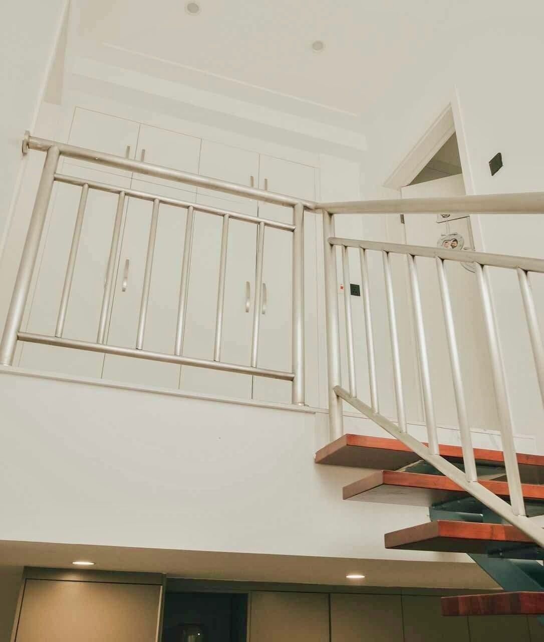A staircase with metal railings and wooden steps.