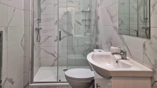 Shower, hair dryer, towels, shampoo