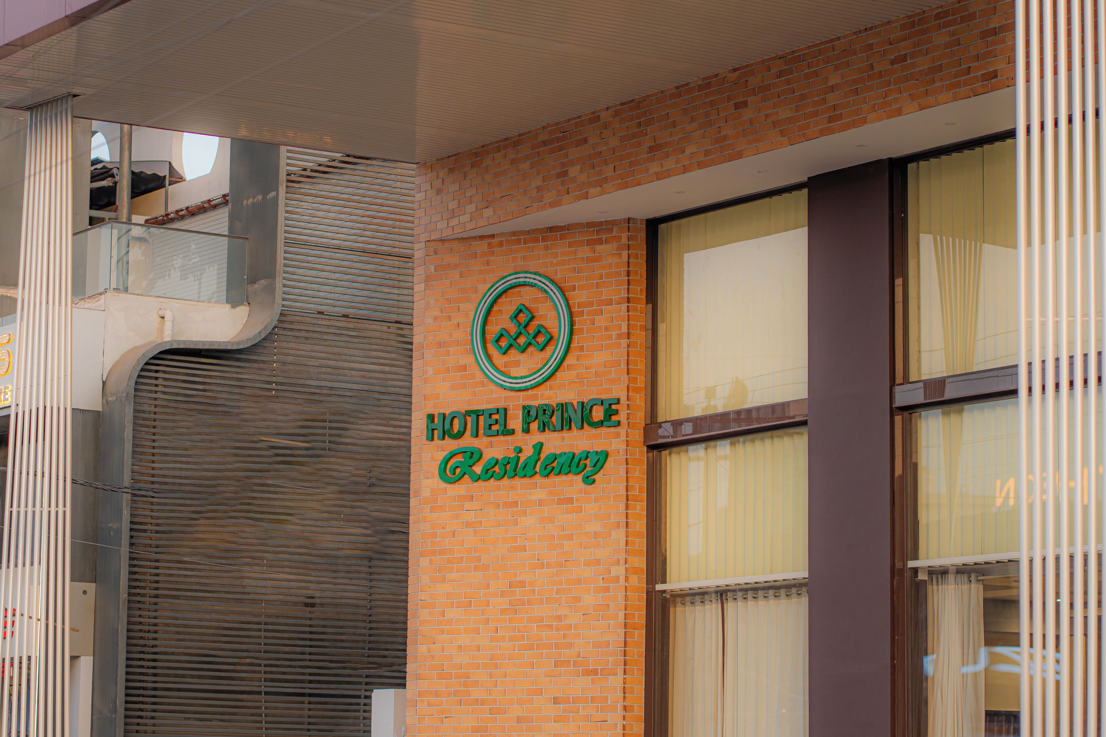A hotel sign with the name 'HOTEL PRINCE Residency' and a logo.