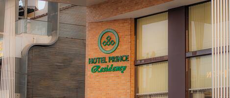 A hotel sign with the name 'HOTEL PRINCE Residency' and a logo.