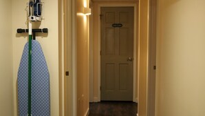 A hallway with a door labeled "Linen Closet" and an ironing board with an iron and board. - Smallwood St Park,Washington DC and Indian Head (Marbury)