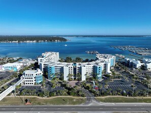 Ein Hotelkomplex an der Küste mit mehreren Gebäuden, Parkplätzen und einem Hafen.